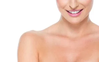 woman smiling with shoulders showing decolletage area