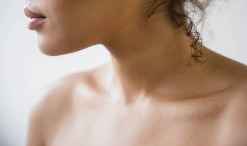 Olive toned woman looking to the side, close up of neck area